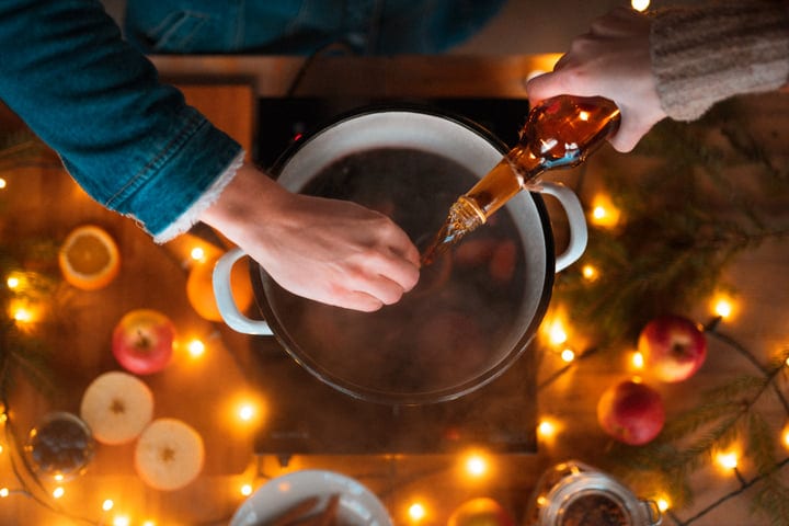 Pouring Warm Spices Into A Winter Cider Pot