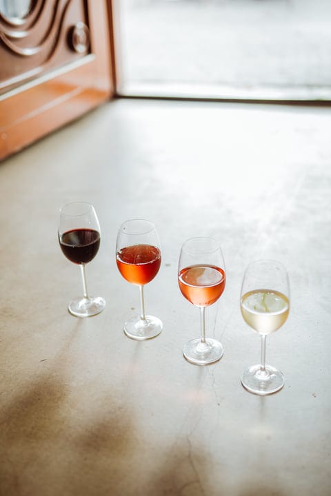Sunlight Dances Across Four Elegant Wine Glasses