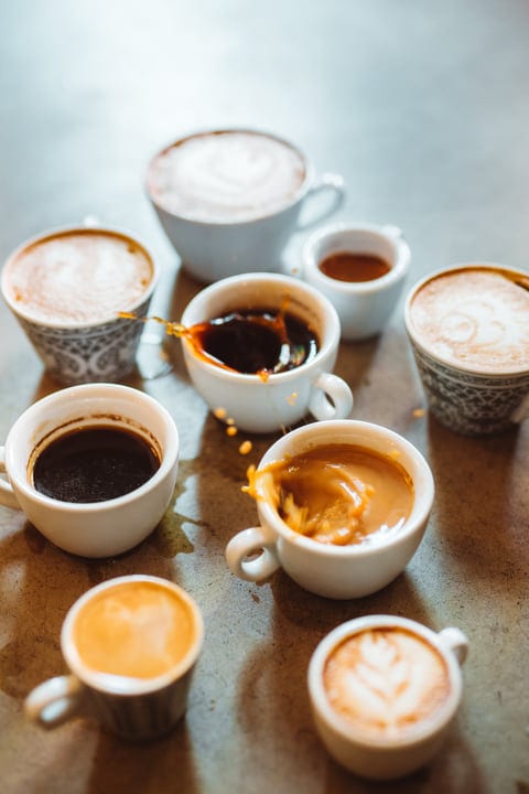 A Symphony of Coffee Cups on a Rustic Table
