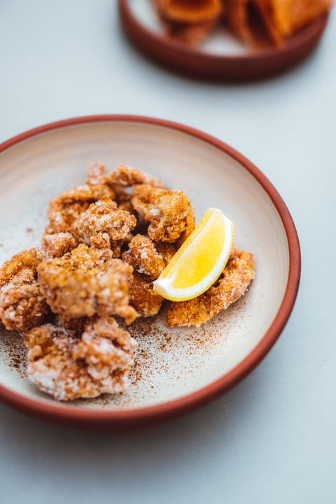 Crispy Bites With Lemon Touch On Earthenware Plate