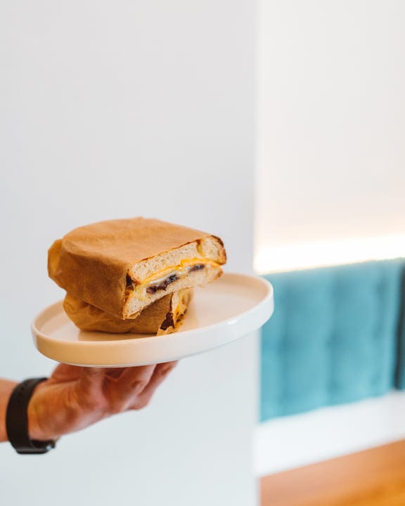 Savoring a Gourmet Sandwich in Minimalist Setting
