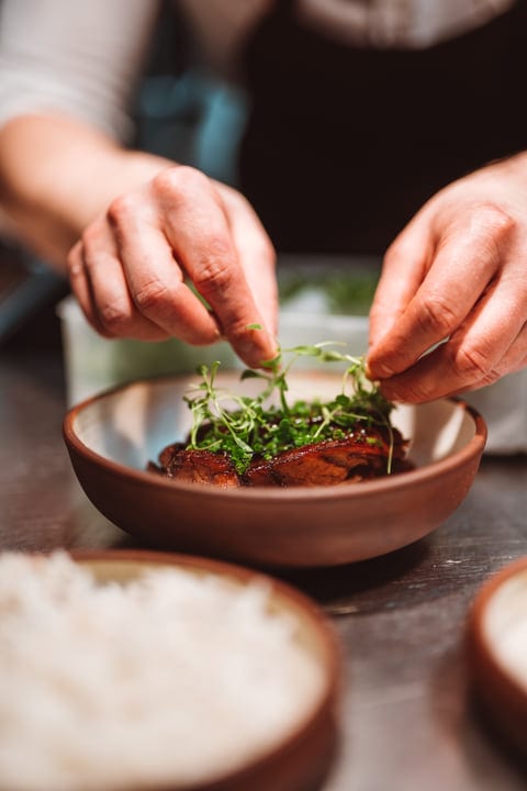 Chef's Hands Perfecting a Seasonal Culinary Masterpiece