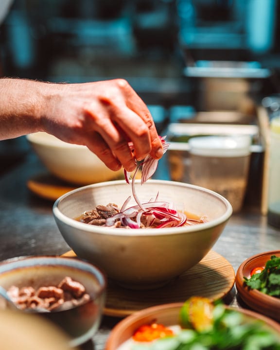 A Chef's Hand Perfects a Gourmet Dish With Precision