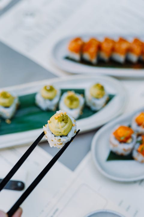 Chopsticks Gracefully Hold Sushi Delicacy With Precision