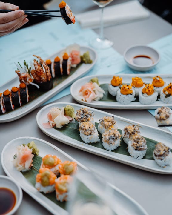Chopsticks Lift Sushi Delights At Outdoor Gathering