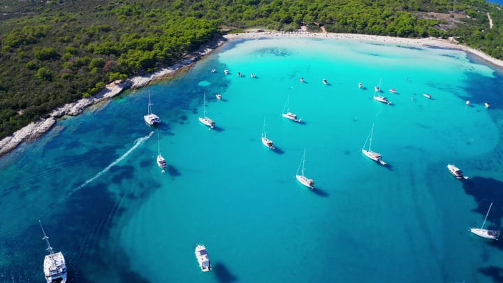 Sailboats Gracefully Float In A Turquoise Bay