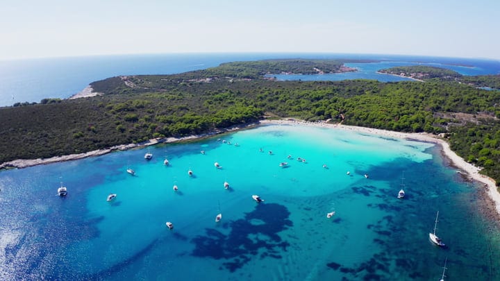 Sailboats Rest Gently in Turquoise Waters Along the Coast