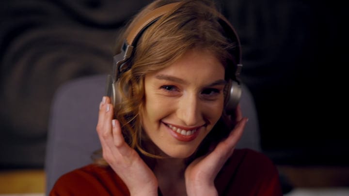 Joyful Woman Immersed in Music at Studio Desk