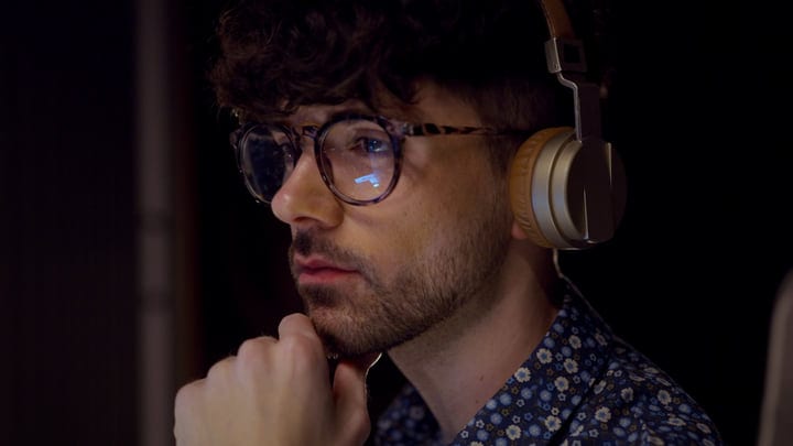 Focused Music Producer Immersed In Creative Studio Atmosphere