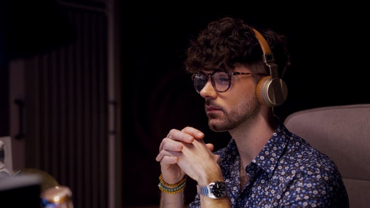Focused Producer Immersed in Sound at Studio Desk