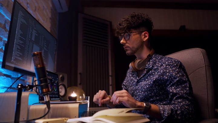 Focused Music Producer at Work in Cozy Studio