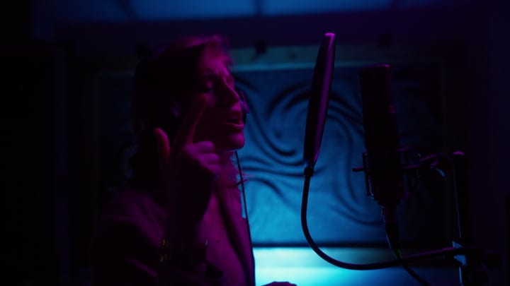 Singer Immersed in Creative Flow Under Studio Lights