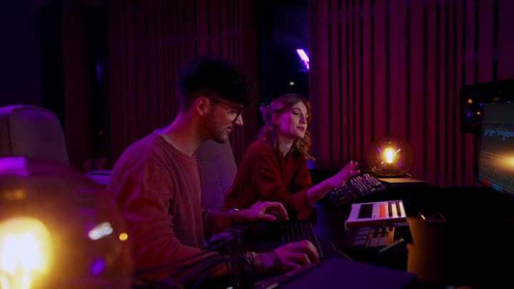 Creative Minds Collaborate In a Dimly Lit Studio
