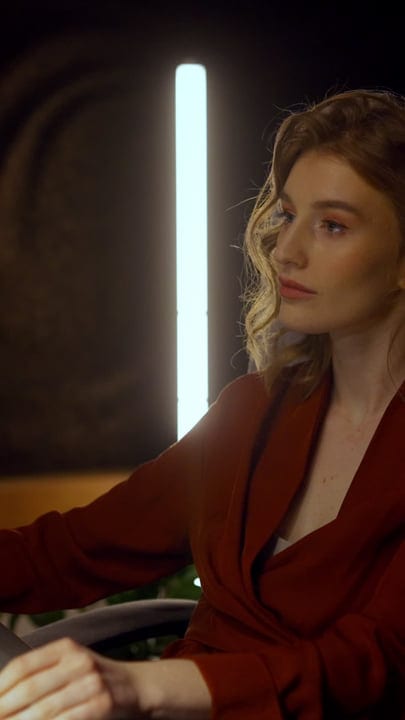 Glimmering Studio Lights Cast A Warm Glow On Her Face