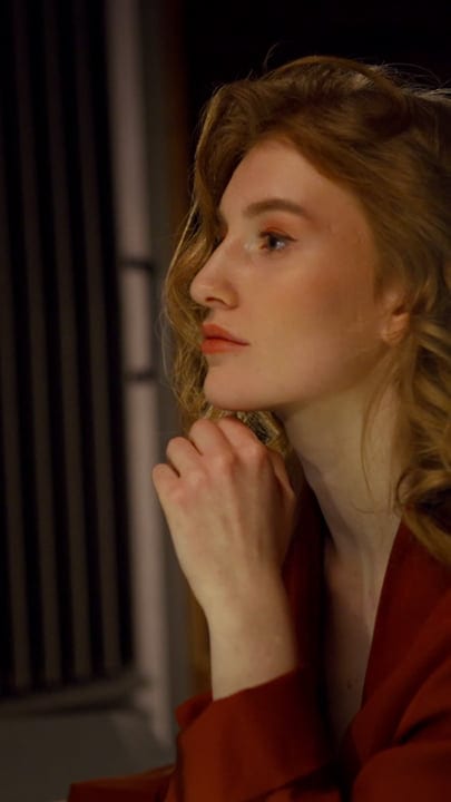 Contemplative Woman in Warm Studio Lighting