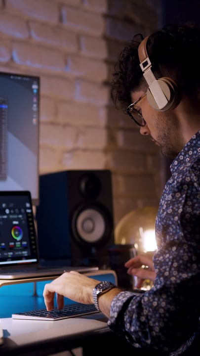 Focused Producer Mixing Beats In Modern Studio Setting