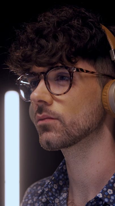 Focused Producer Immersed in Studio Soundscape