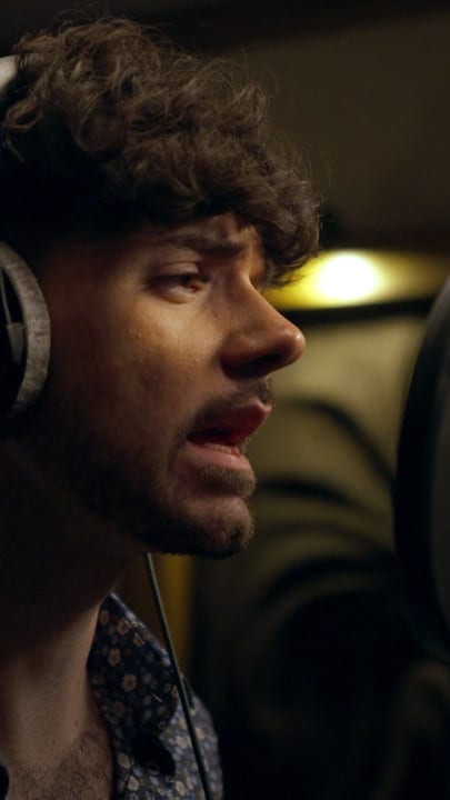 Focused Music Producer Listens Intently in Studio Session