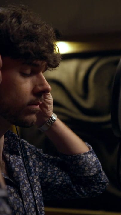 Focused Music Producer Listens Intently In Studio Session