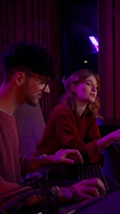 Creative Collaboration Under Studio Lights In Vibrant Session