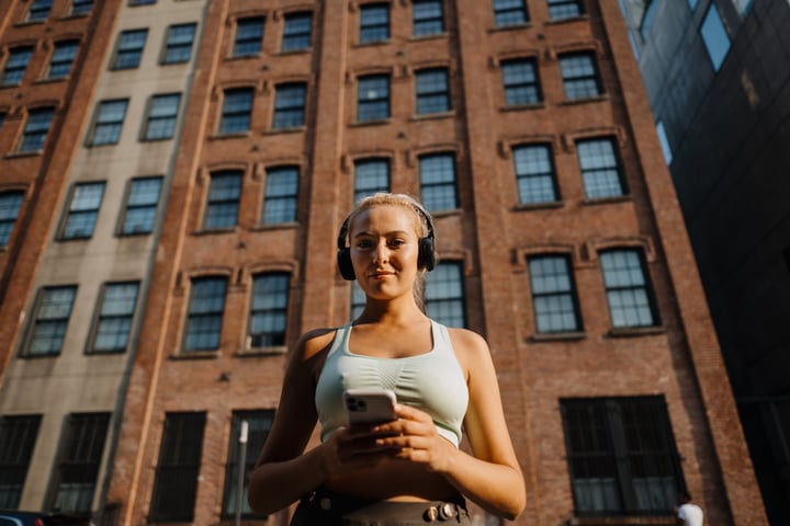 Morning Jogger Embraces the City’s Rhythms with Headphones