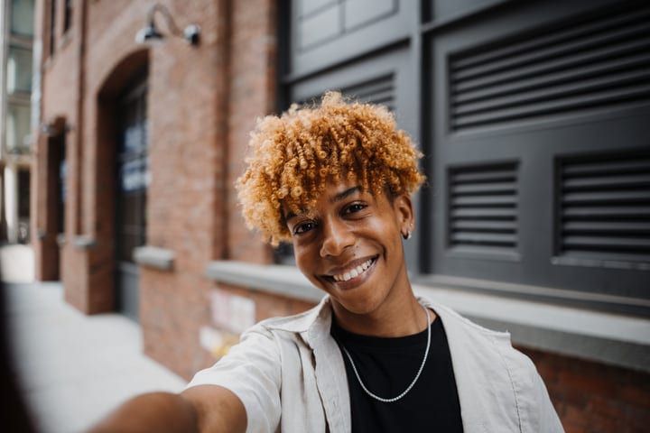 Smiling Individual Captures Joy On City Street