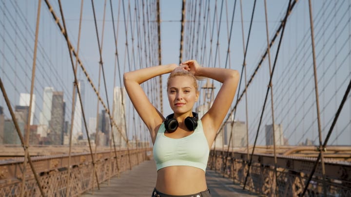 Runner Embraces the Morning on Brooklyn Bridge