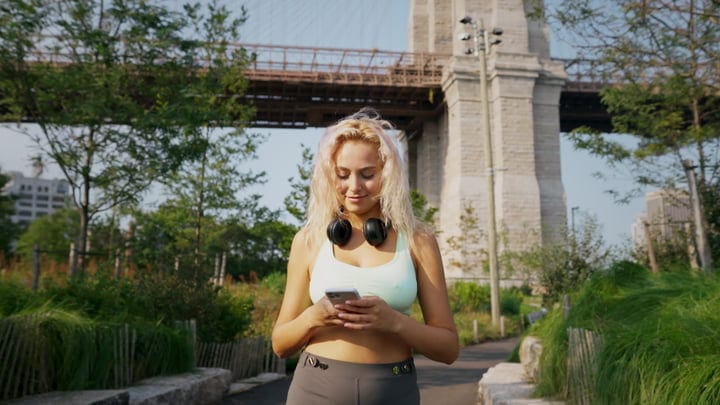 Urban Runner Checks Her Playlist Near Brooklyn Bridge