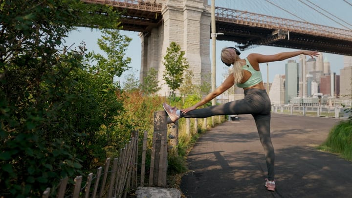 Stretching at Sunrise Under the Iconic Brooklyn Bridge