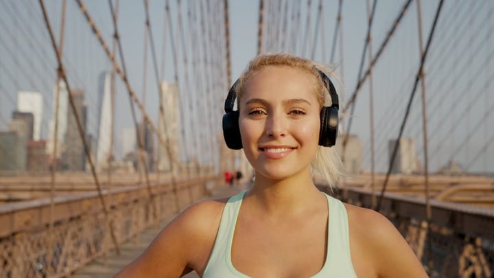 Sunlit Smiles and Headphones on Brooklyn Bridge