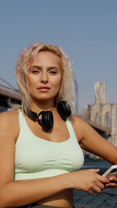 Runner Pauses By Brooklyn Bridge With Headphones