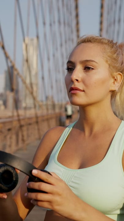 Morning Light Catches Runner's Determined Gaze On Urban Bridge