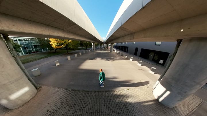 Urban Dancer Weaving Through Geometric Shadows In Daylight