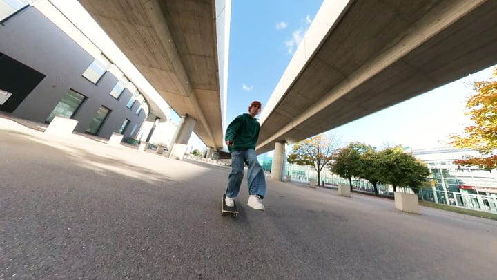 Young Skater Glides Through Urban Autumn Underpass