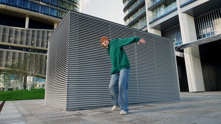 Street Dancer Twirls Amid Urban Architecture Vibes