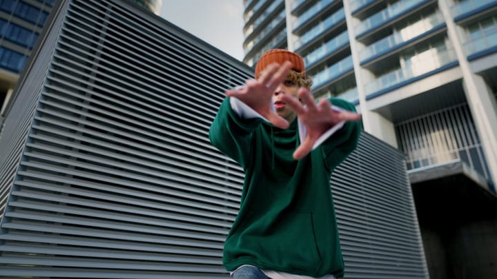 Dynamic Street Dance Moves Against Urban Backdrop