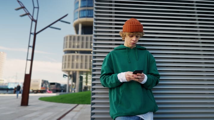 Urban Youth Engages With Technology In The Cityscape