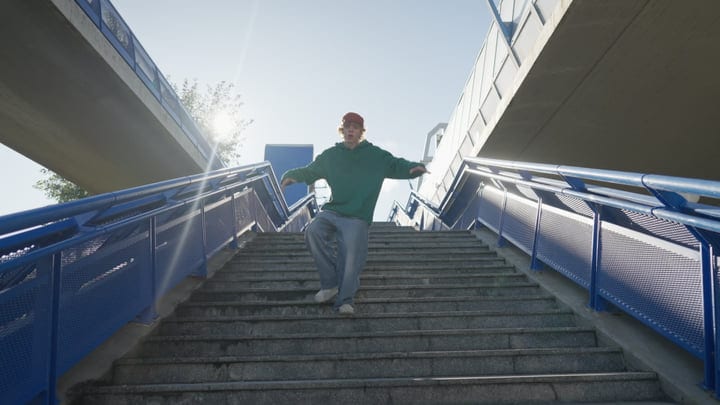 A Street Dancer Glides Down Sunlit Urban Steps