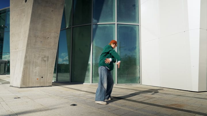 Dynamic Moves Against A Modern Architectural Backdrop