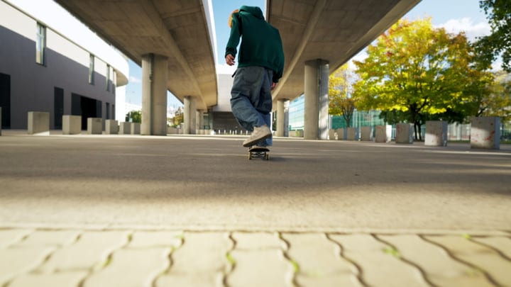 Under The Overpass, A Skater Glides Into Autumn's Embrace