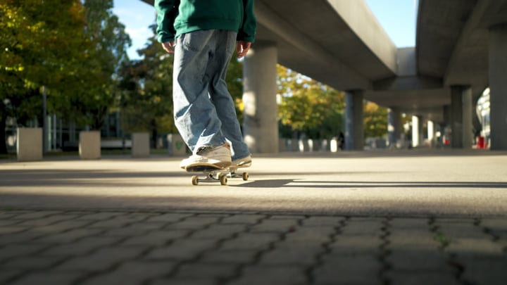 Skater Glides Effortlessly Under Urban Overpass