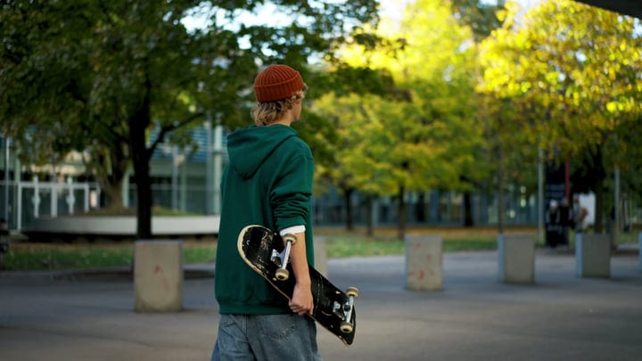 Young Skater Embraces Autumn Vibes in Urban Park