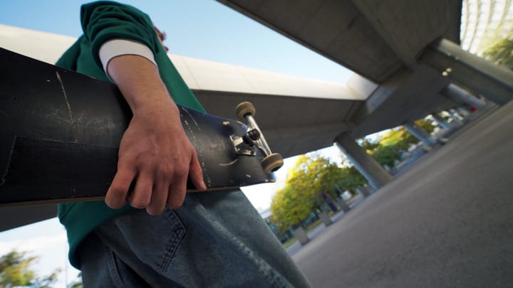 Young Skater Embraces the Urban Night Under Bridge