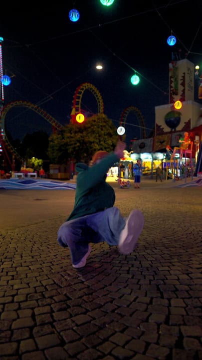 Energetic Street Dancer Spins Under Vibrant Night Lights