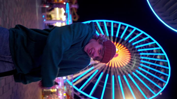 Street Dancer's Night Moves Under Neon Ferris Wheel Lights