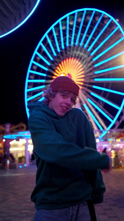 A Dancer's Joy Under Neon Carnival Lights