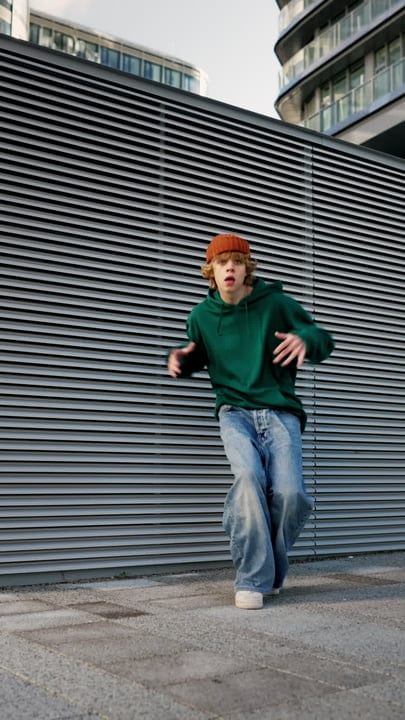 Young Dancer Moves Freely Against Urban Backdrop