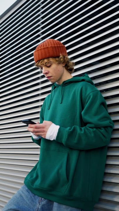 Urban Youth Engages With Technology On A Chilly Night