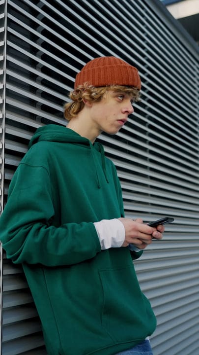 Urban Youth Engages With Technology In Cityscape