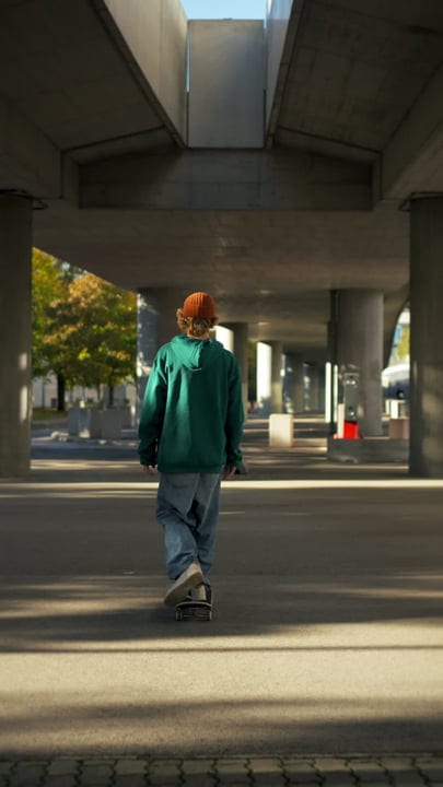 Skater Glides Through Sunlit Urban Pathway
